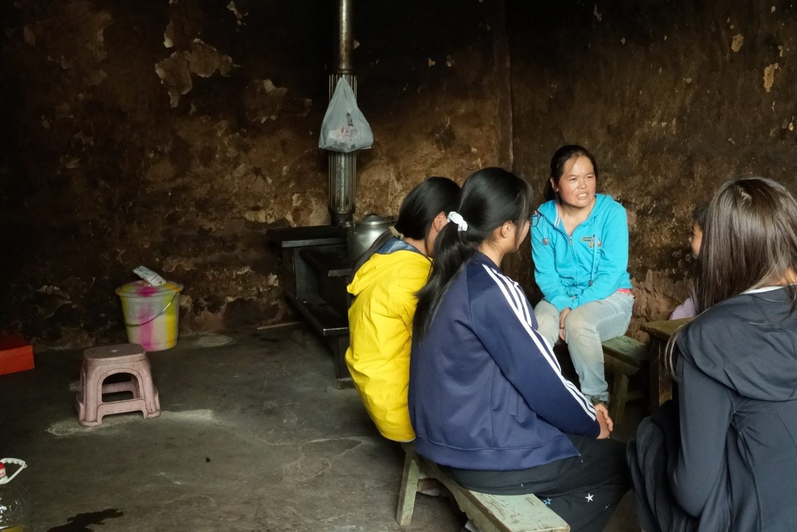 Volunteers interviewing a villager inside her home
